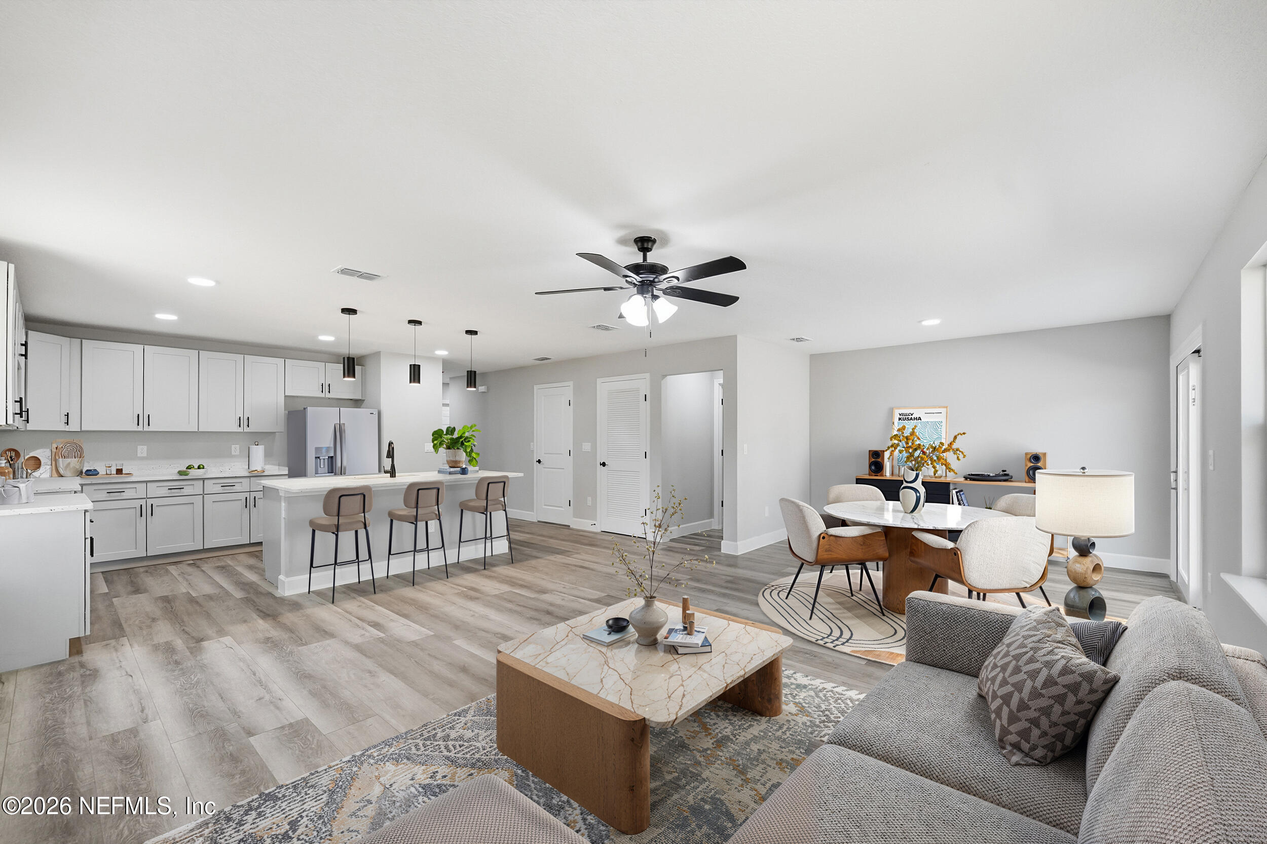 5259 Shenandoah Avenue Jacksonville, FL 32254 - Photo 10 of 51 a living room with furniture and a dining table with kitchen view