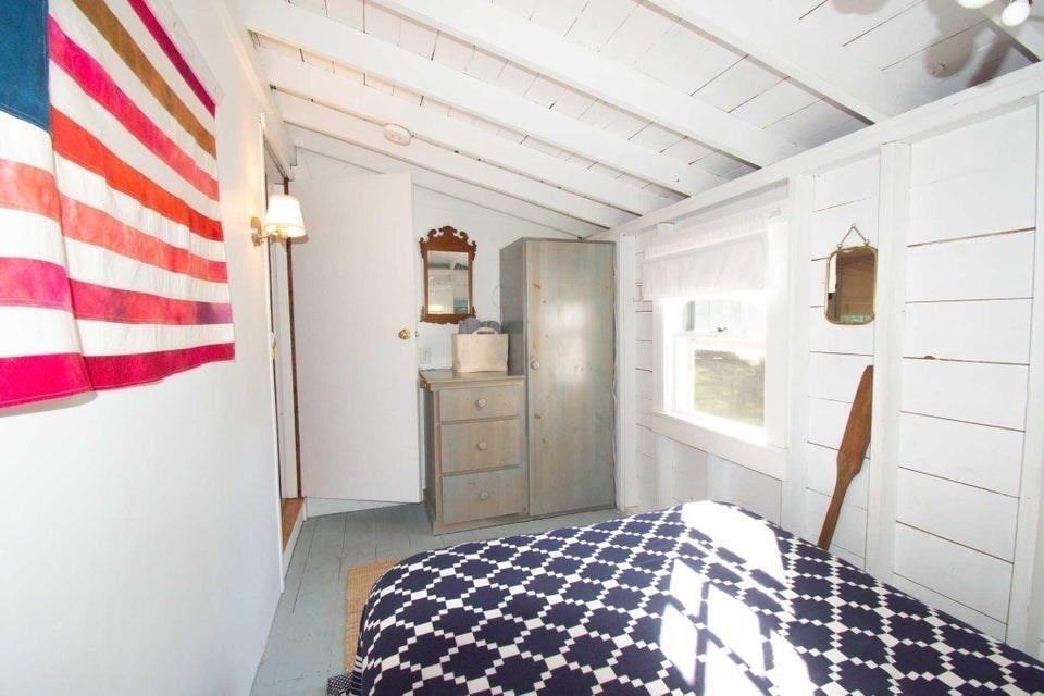 50 Mill Road Eastham, MA 02642 - Photo 13 of 26 a bedroom with a bed and a cabinets