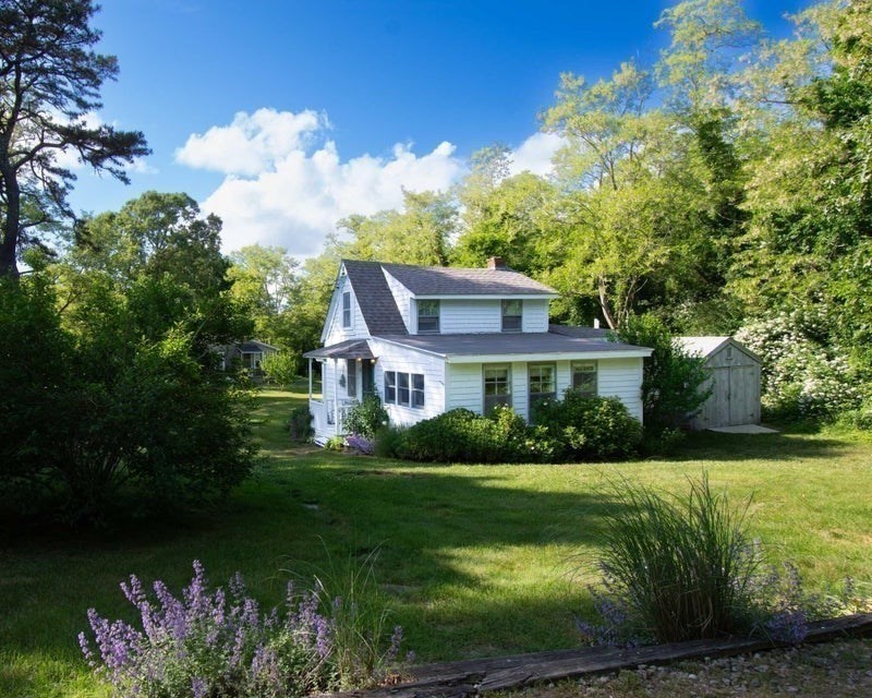 50 Mill Road Eastham, MA 02642 - Photo 21 of 26 a front view of a house with garden