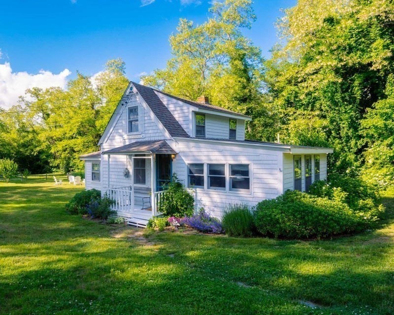 50 Mill Road Eastham, MA 02642 - Photo 22 of 26 a front view of a house with a yard