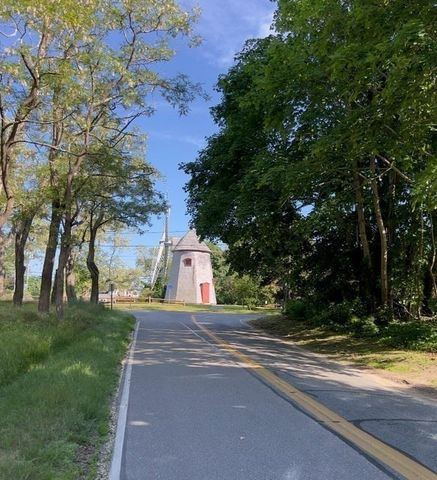 a view of a swimming pool with lawn chairs and plants