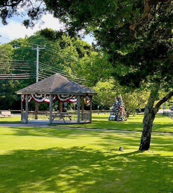 50 Mill Road Eastham, MA 02642 - Photo 26 of 26 a view of a swimming pool with lawn chairs and plants