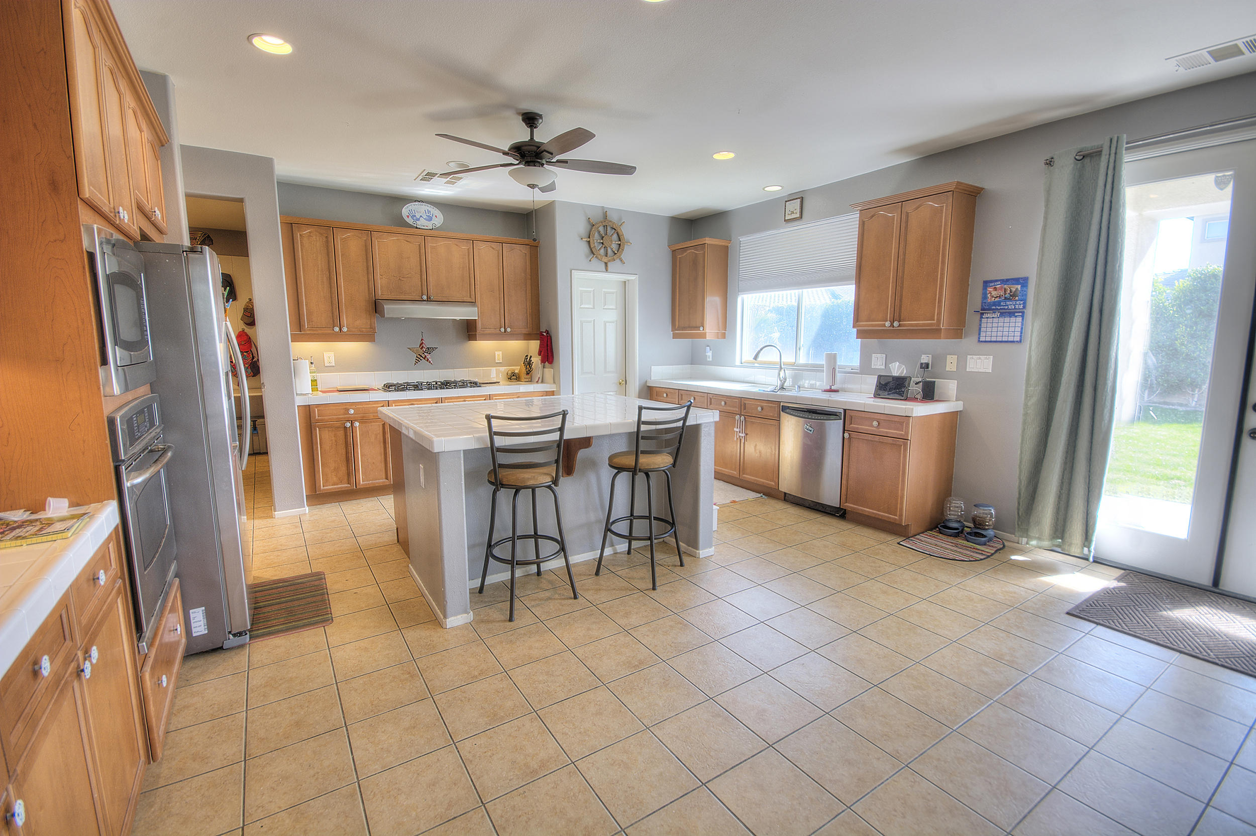 83387 Lightning Road Indio, CA 92203 - Photo 11 of 20 a kitchen with stainless steel appliances granite countertop a refrigerator and a stove top oven