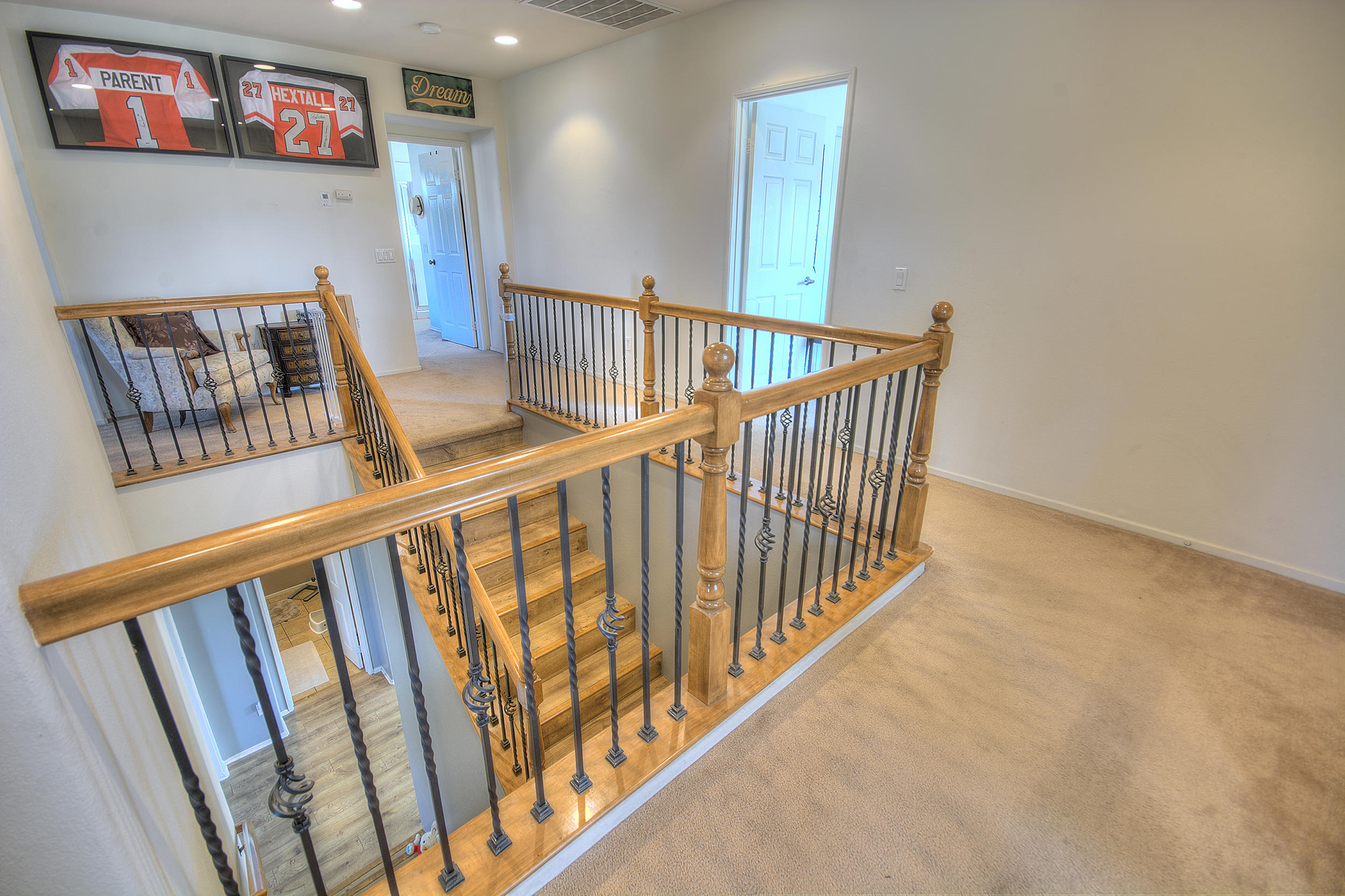 83387 Lightning Road Indio, CA 92203 - Photo 16 of 20 a view of staircase with lots of frames on wall and wooden floor
