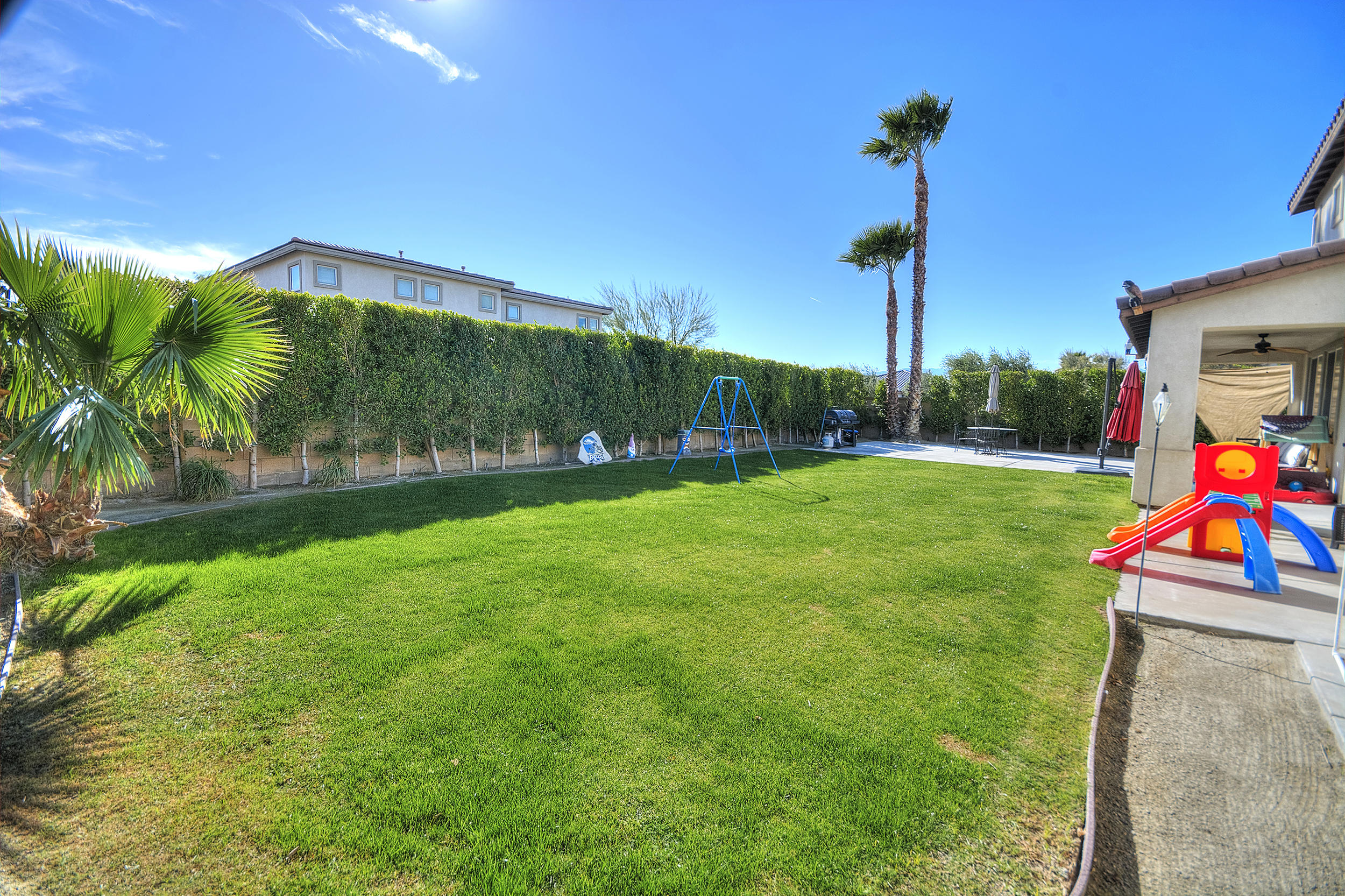 83387 Lightning Road Indio, CA 92203 - Photo 3 of 20 a view of a backyard with swimming pool and plants