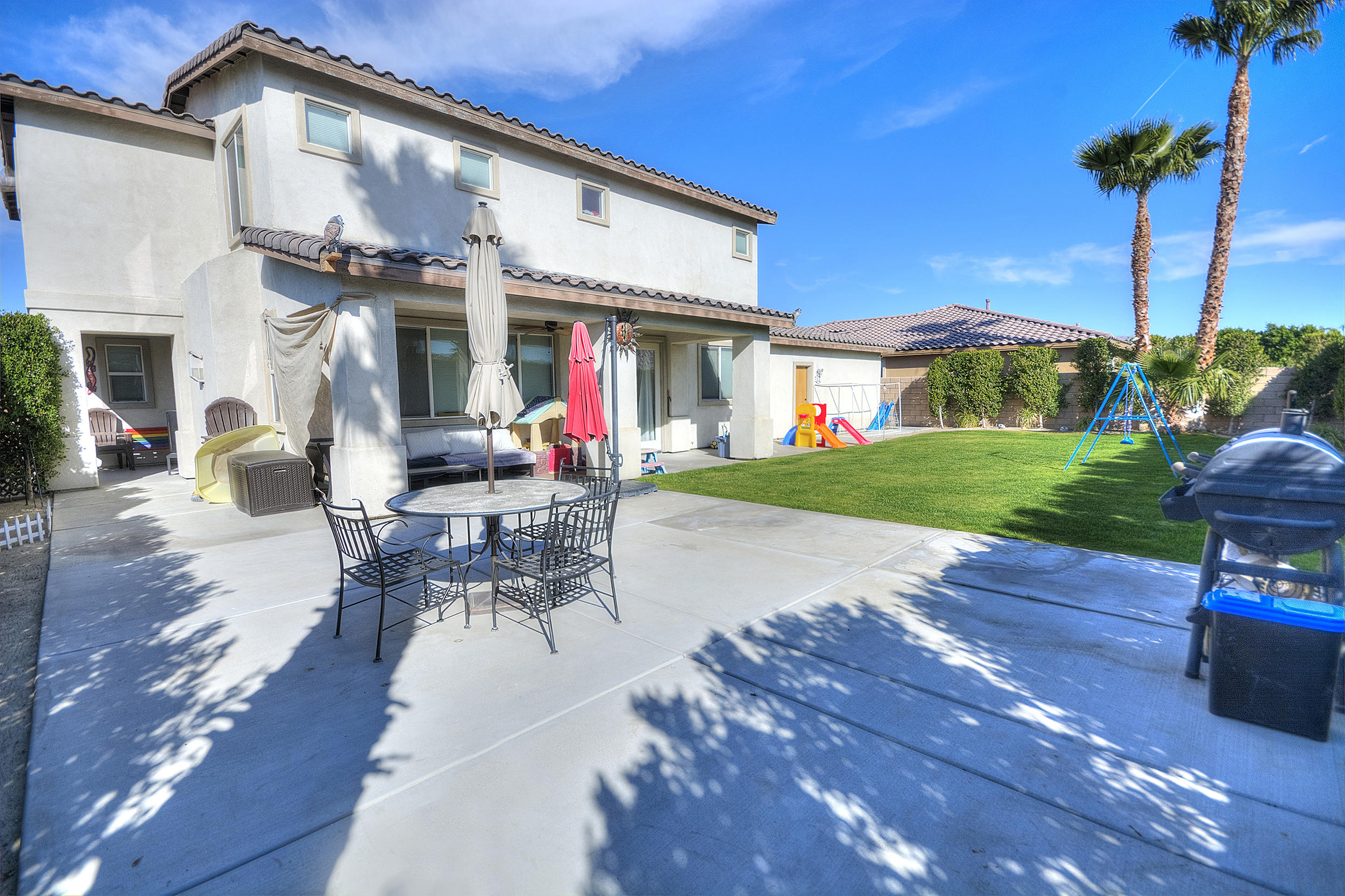 83387 Lightning Road Indio, CA 92203 - Photo 4 of 20 a view of a patio with couches table and chairs and potted plants