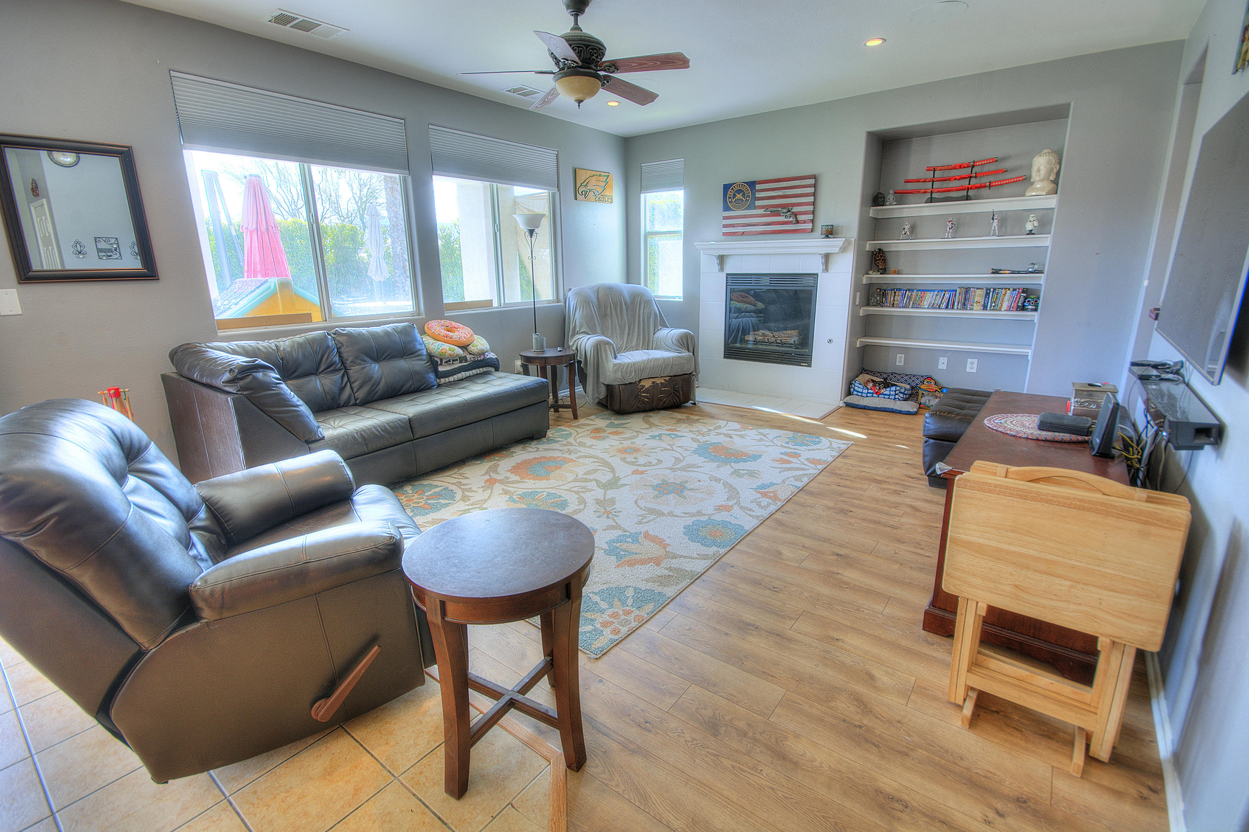 83387 Lightning Road Indio, CA 92203 - Photo 9 of 20 a living room with furniture a flat screen tv and a fireplace