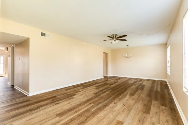 a view of a room with wooden floor