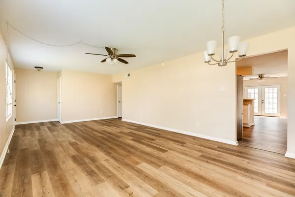 a view of a chandelier fan and wooden floor
