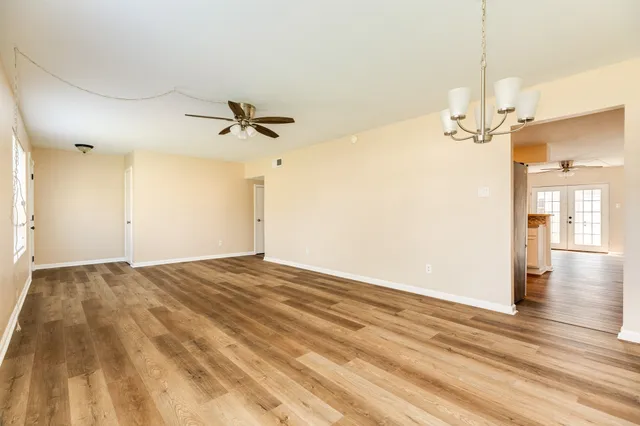 a view of a chandelier fan and wooden floor