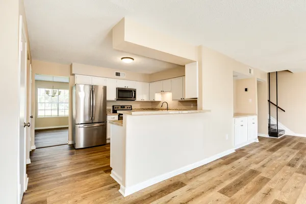 a kitchen with stainless steel appliances a refrigerator and a stove top oven