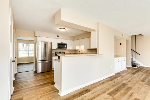 a kitchen with stainless steel appliances a refrigerator and a stove top oven