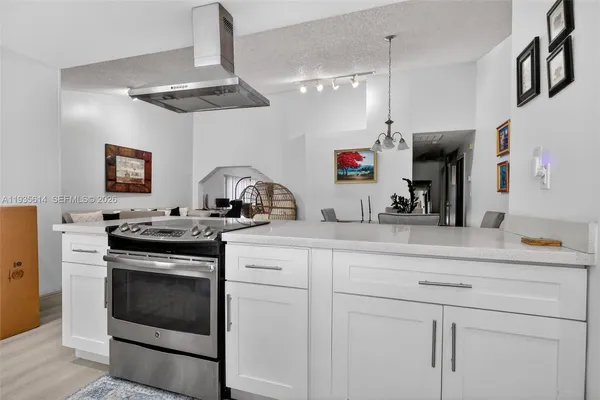 a kitchen with a sink stove and cabinets