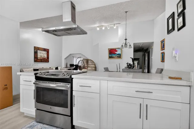 a kitchen with a sink stove and cabinets