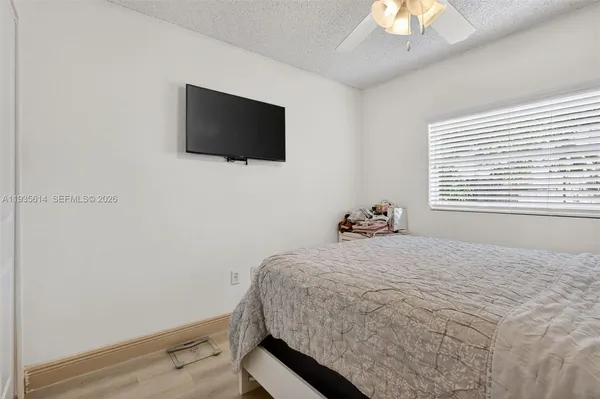 a bedroom with a bed and a flat screen tv