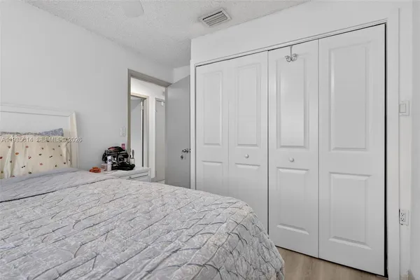 a bedroom with a bed and a closet