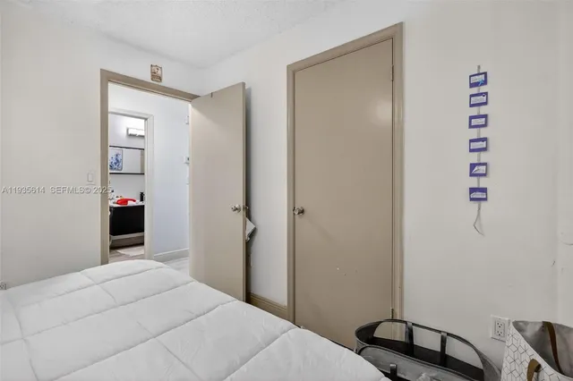 a bedroom with a bed and a desk