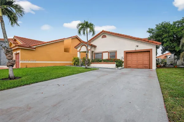 a view of a house with a yard and garage