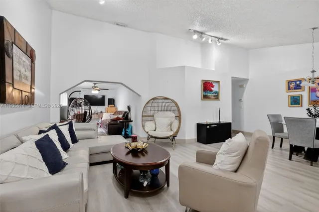 a living room with furniture a rug and a mirror