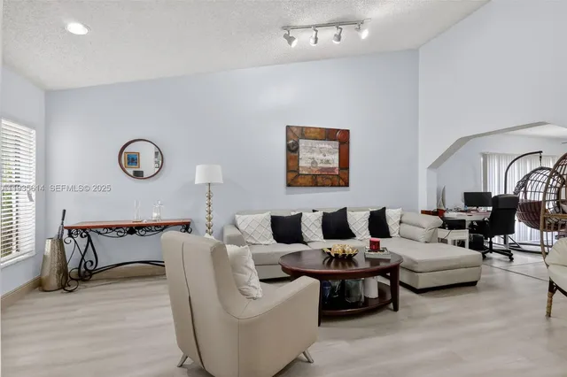 a living room with furniture and wooden floor