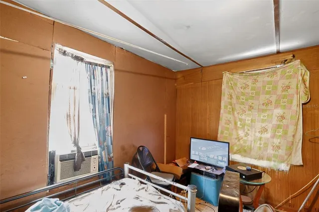 a bedroom with a bed and a large mirror with a chandelier