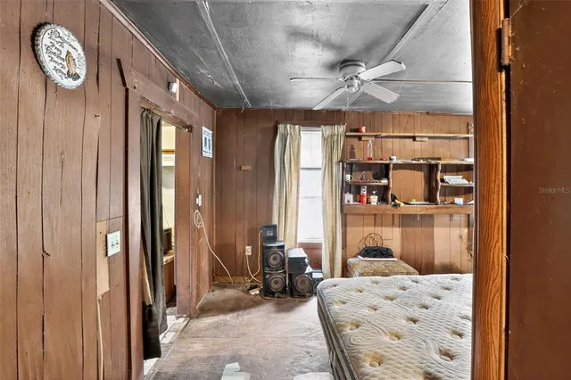 a bed room with a bed and a television