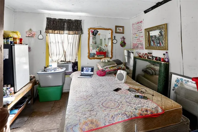 a bedroom with a large bed and a large mirror