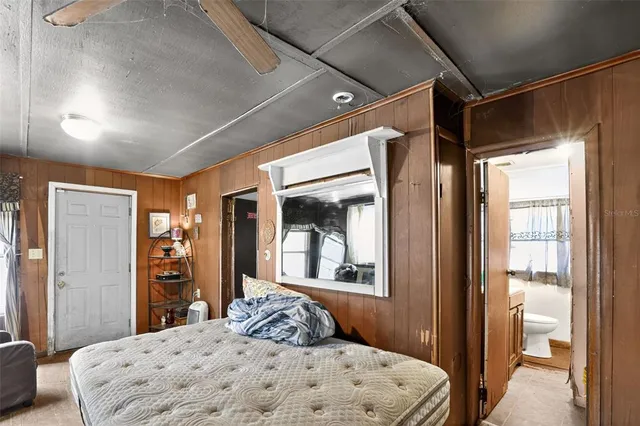 a bedroom with a bed and a couch