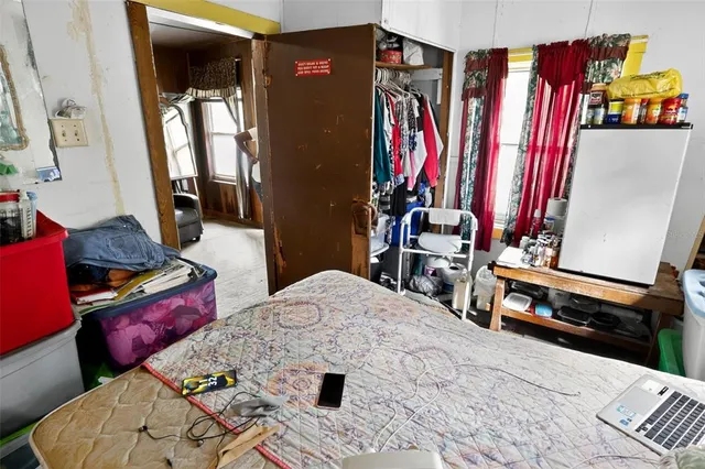 a bedroom with a large bed and a window