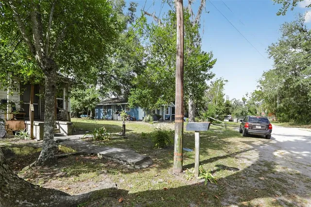 a view of a backyard with chairs