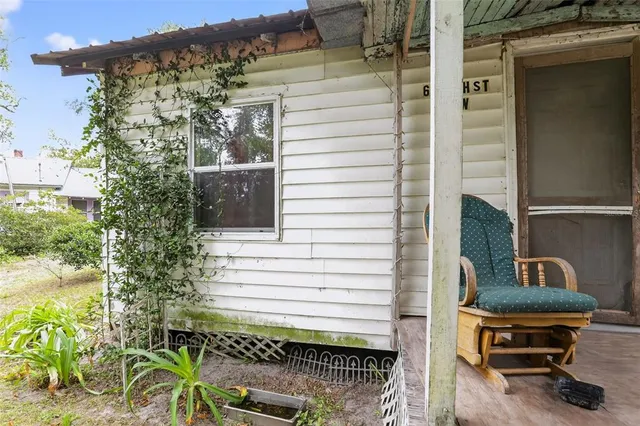 a view of a porch with chairs and a potted plant