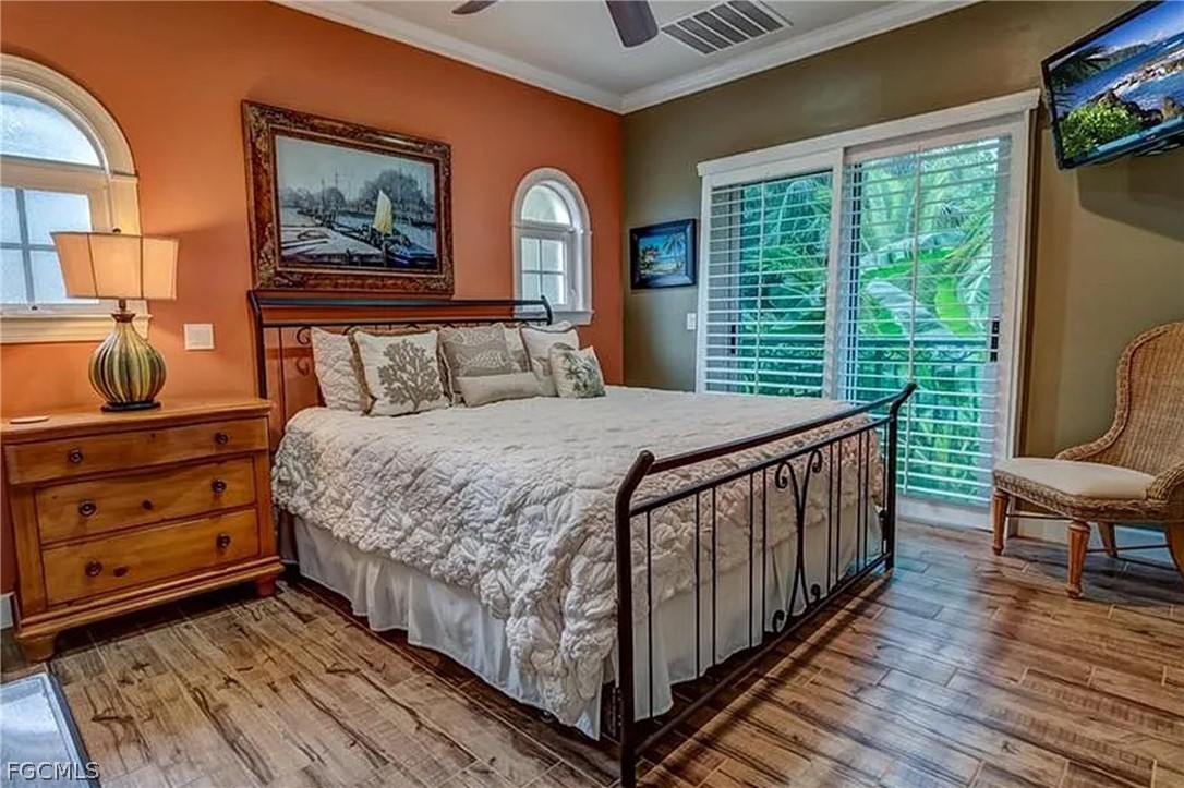 11551 Wightman Lane Captiva, FL 33924 - Photo 12 of 38 a bed sitting in a bedroom next to a window
