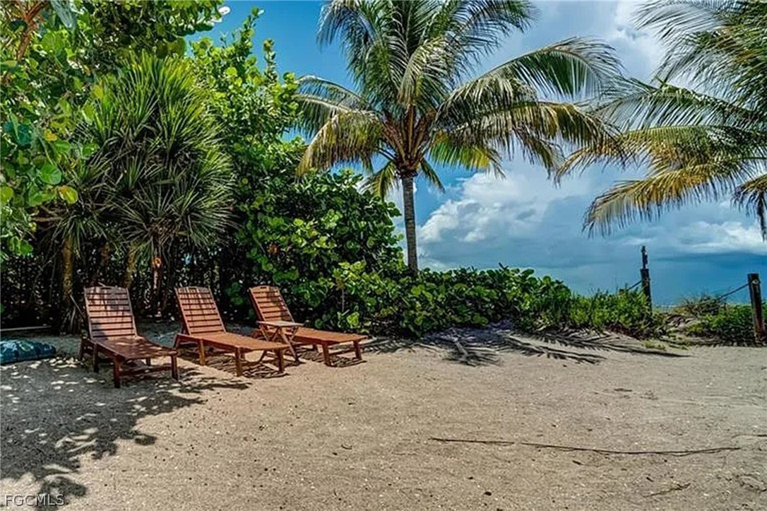 11551 Wightman Lane Captiva, FL 33924 - Photo 16 of 38 a row of palm trees in front of house