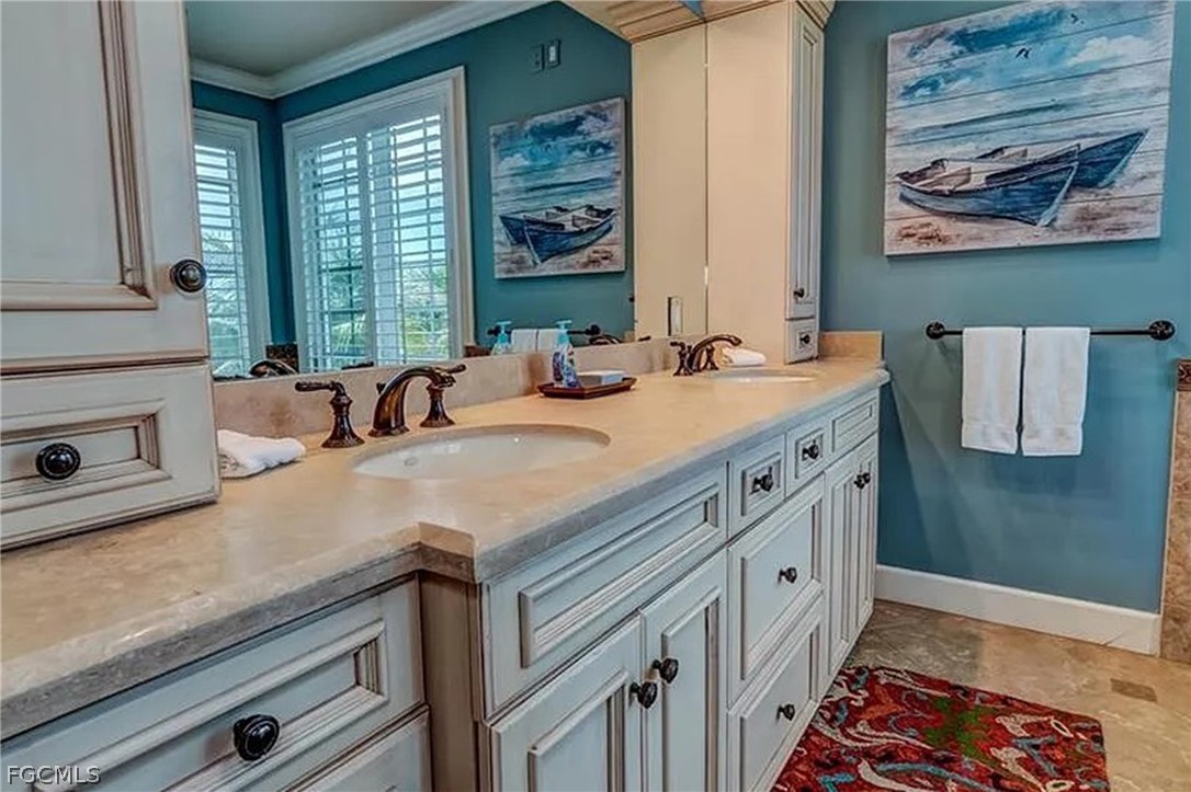 11551 Wightman Lane Captiva, FL 33924 - Photo 9 of 38 a bathroom with a sink a large mirror and a window
