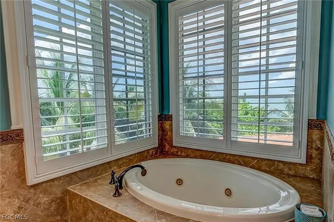 11551 Wightman Lane Captiva, FL 33924 - Photo 10 of 38 a bathroom with a tub and window