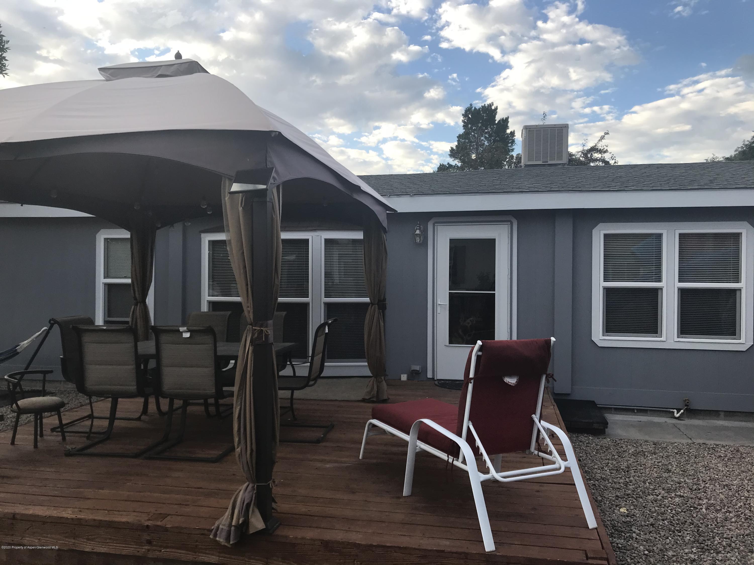 106 Cedar Circle Parachute, CO 81635 - Photo 1 of 22 a patio with table and chairs