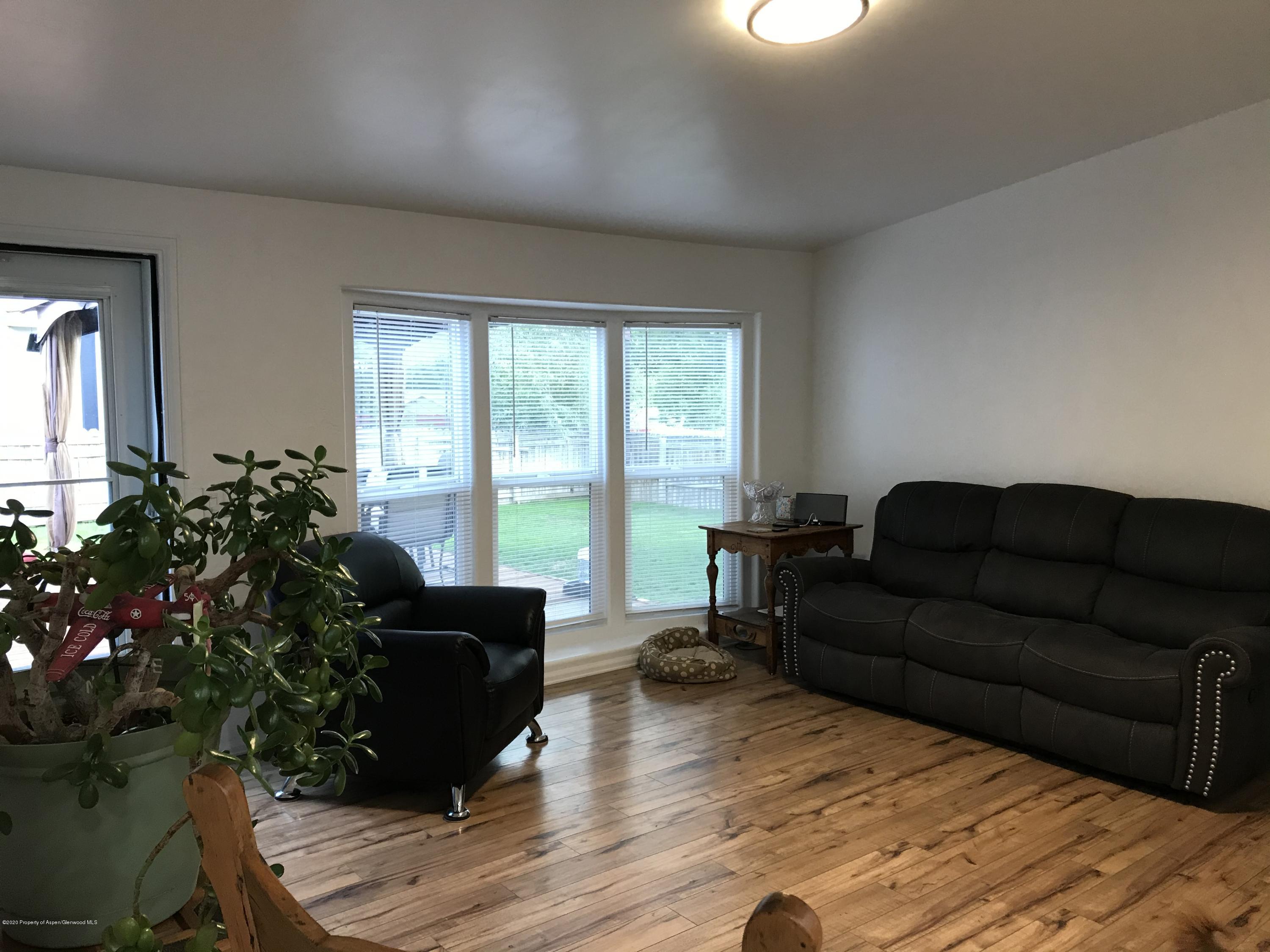 106 Cedar Circle Parachute, CO 81635 - Photo 2 of 22 a living room with furniture and a large window