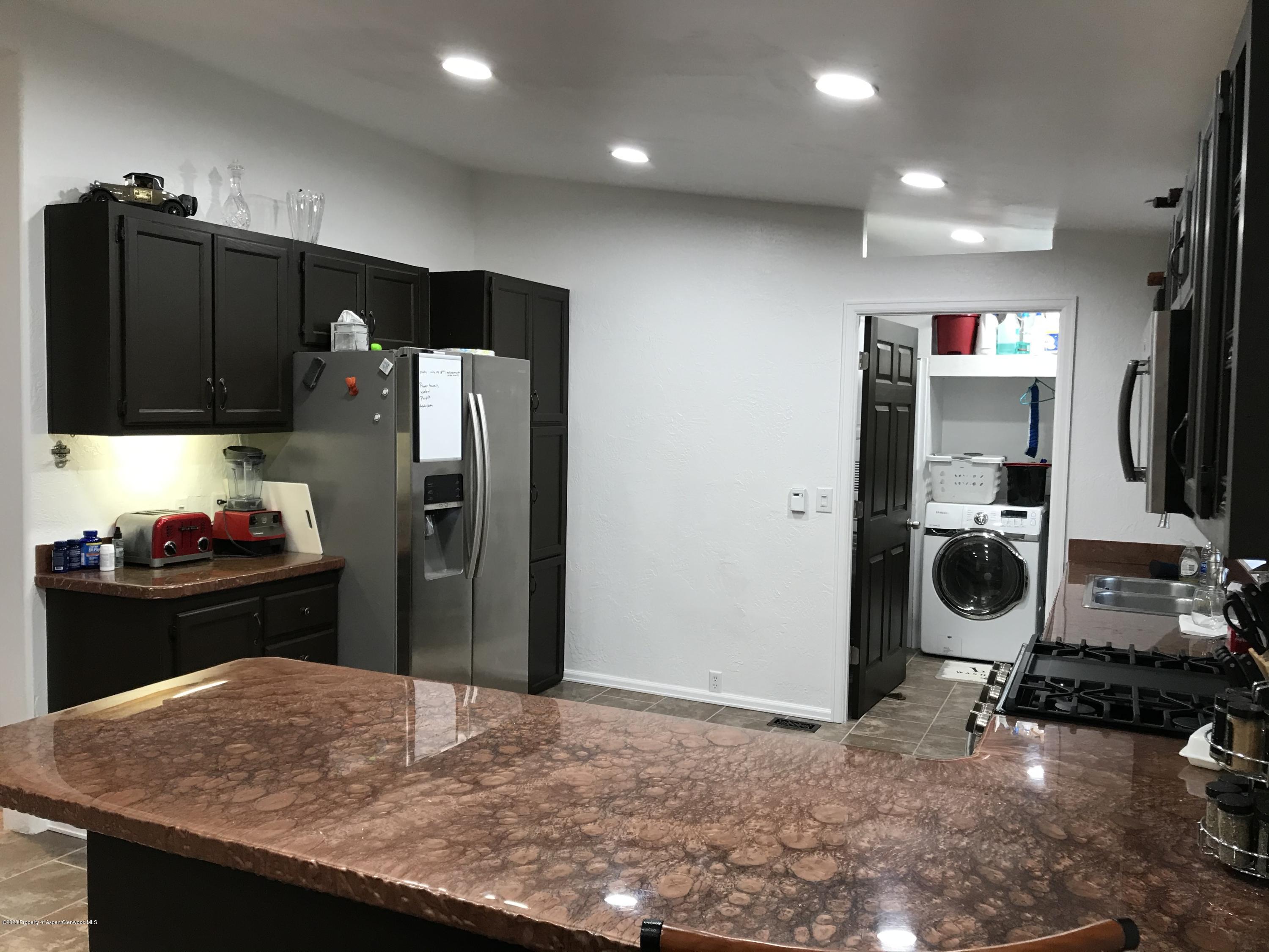 106 Cedar Circle Parachute, CO 81635 - Photo 8 of 22 a kitchen with refrigerator and window