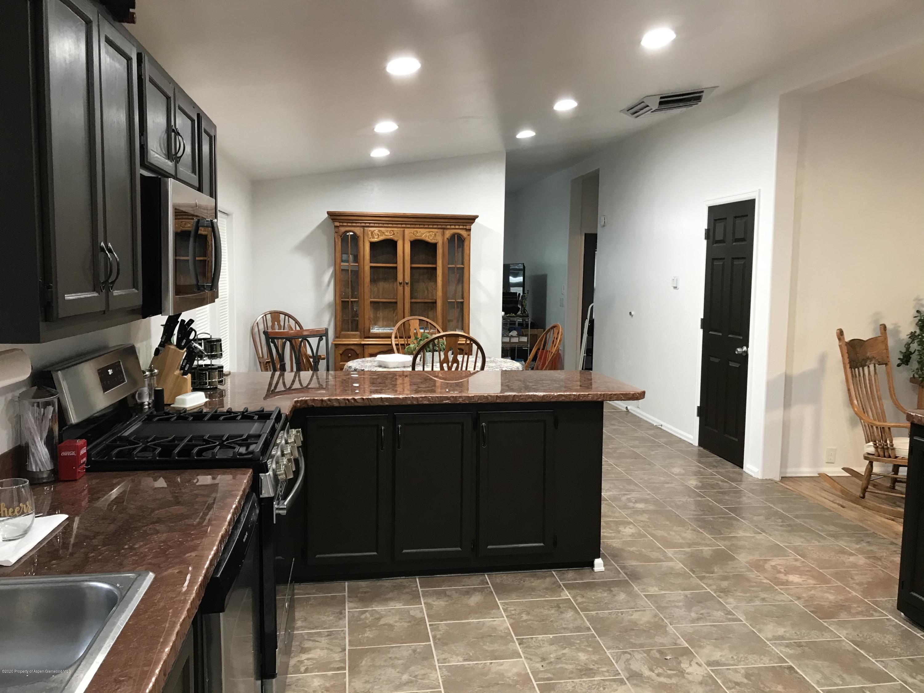 106 Cedar Circle Parachute, CO 81635 - Photo 9 of 22 a kitchen with granite countertop a sink stove and cabinets
