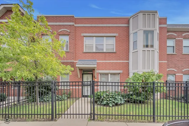 a view of a brick building next to a yard