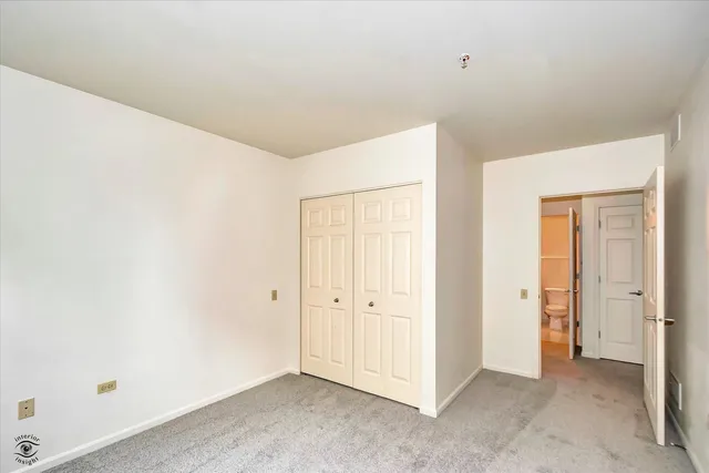 an empty room with closet area