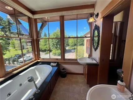 a bathroom with a tub sink and window