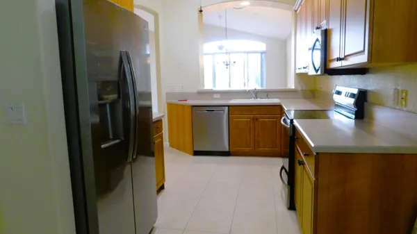 a kitchen with a refrigerator sink and stove
