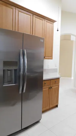 a kitchen with stainless steel appliances granite countertop a refrigerator and a sink
