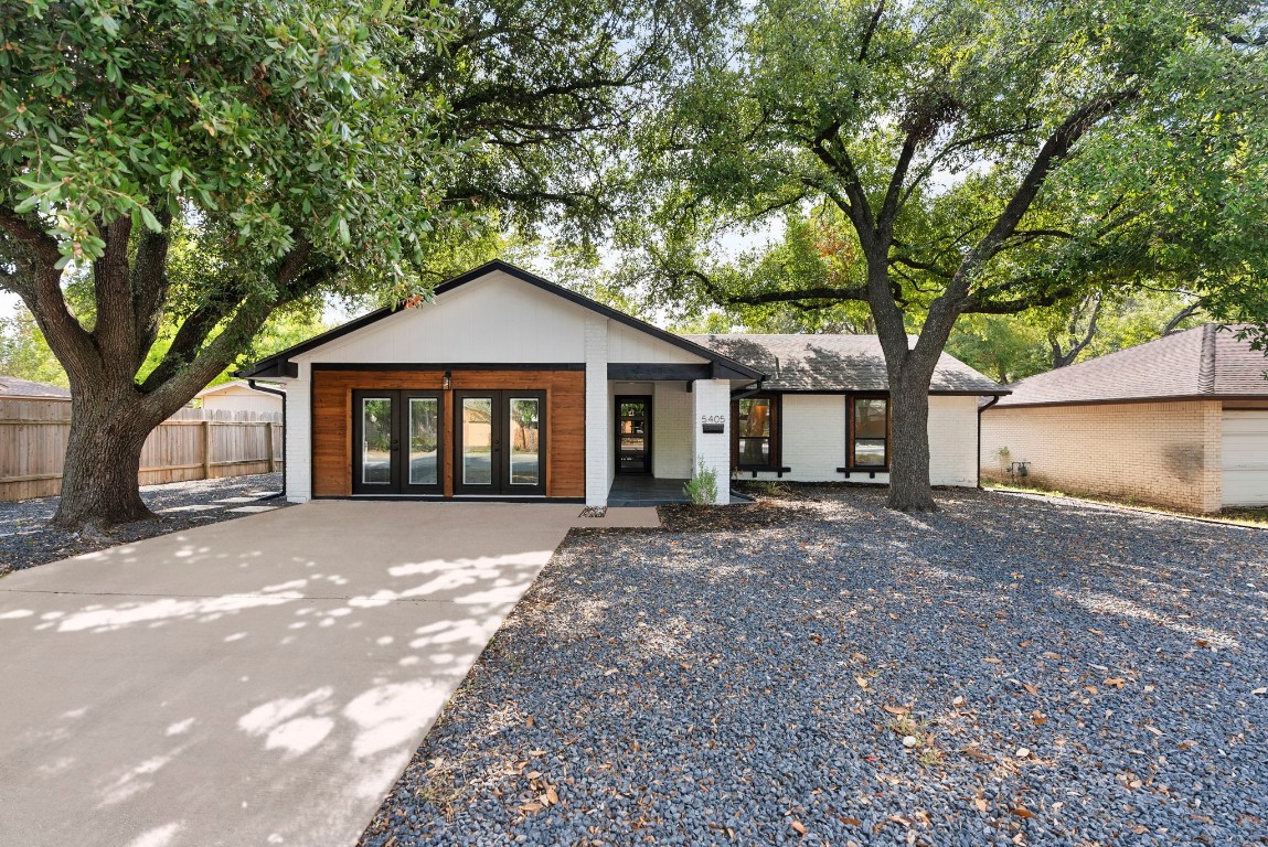 5405 Emerald Forest Drive Austin, TX 78745 - Photo 1 of 1 a front view of a house with a yard and garage