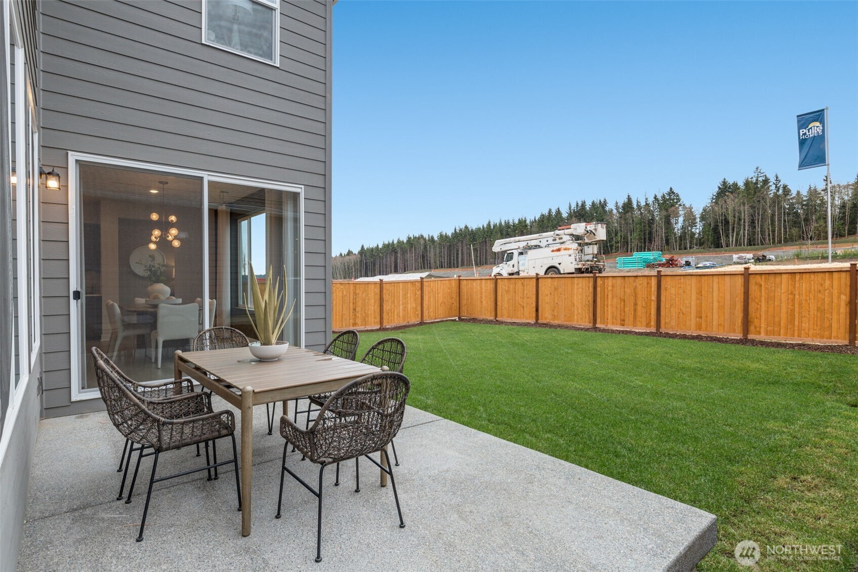 23338 Arbors Ter Road Northeast, Unit 201 Kingston, WA 98346 - Photo 16 of 17 a view of a patio with a table and chairs