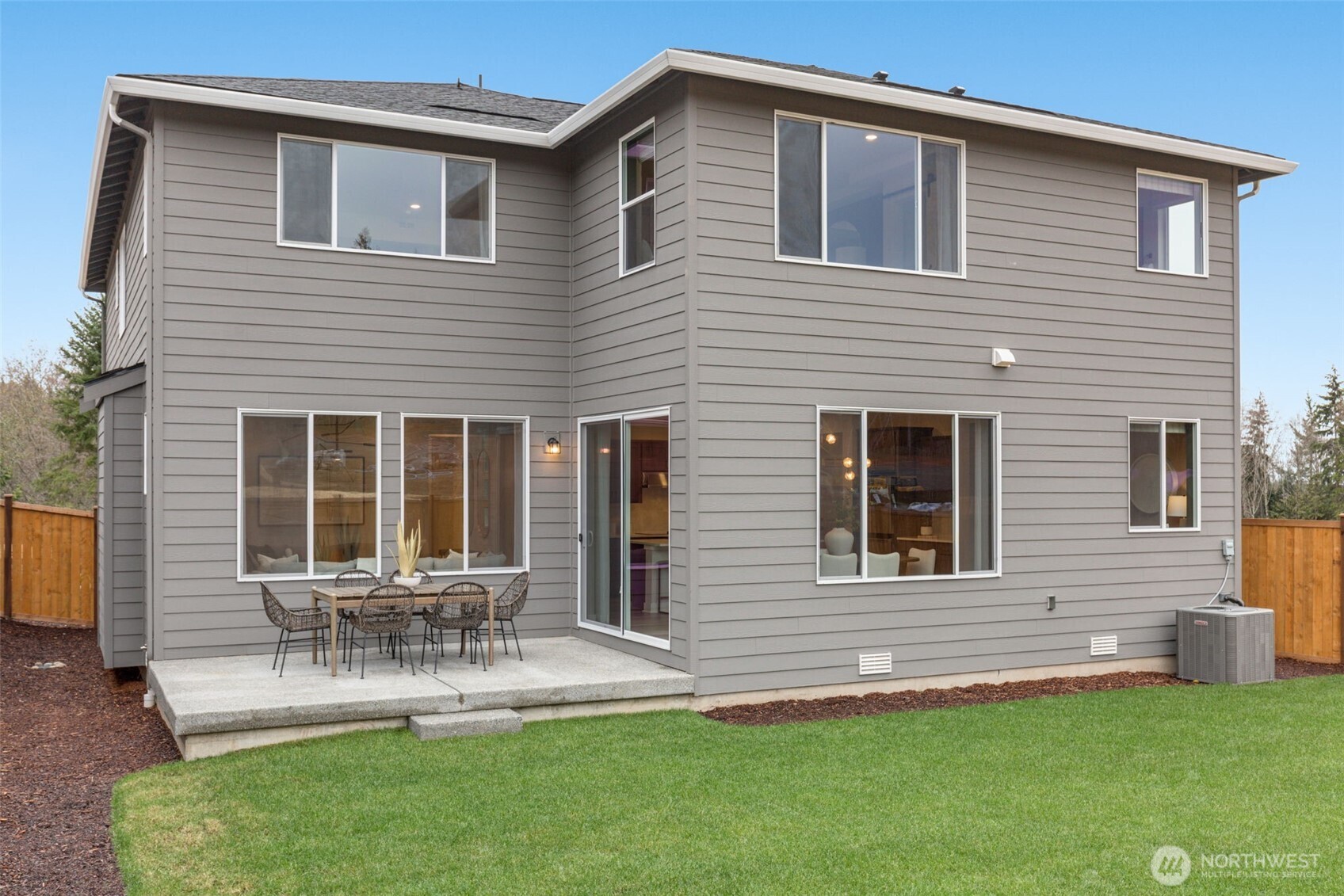 23338 Arbors Ter Road Northeast, Unit 201 Kingston, WA 98346 - Photo 17 of 17 a front view of house with a yard and outdoor seating