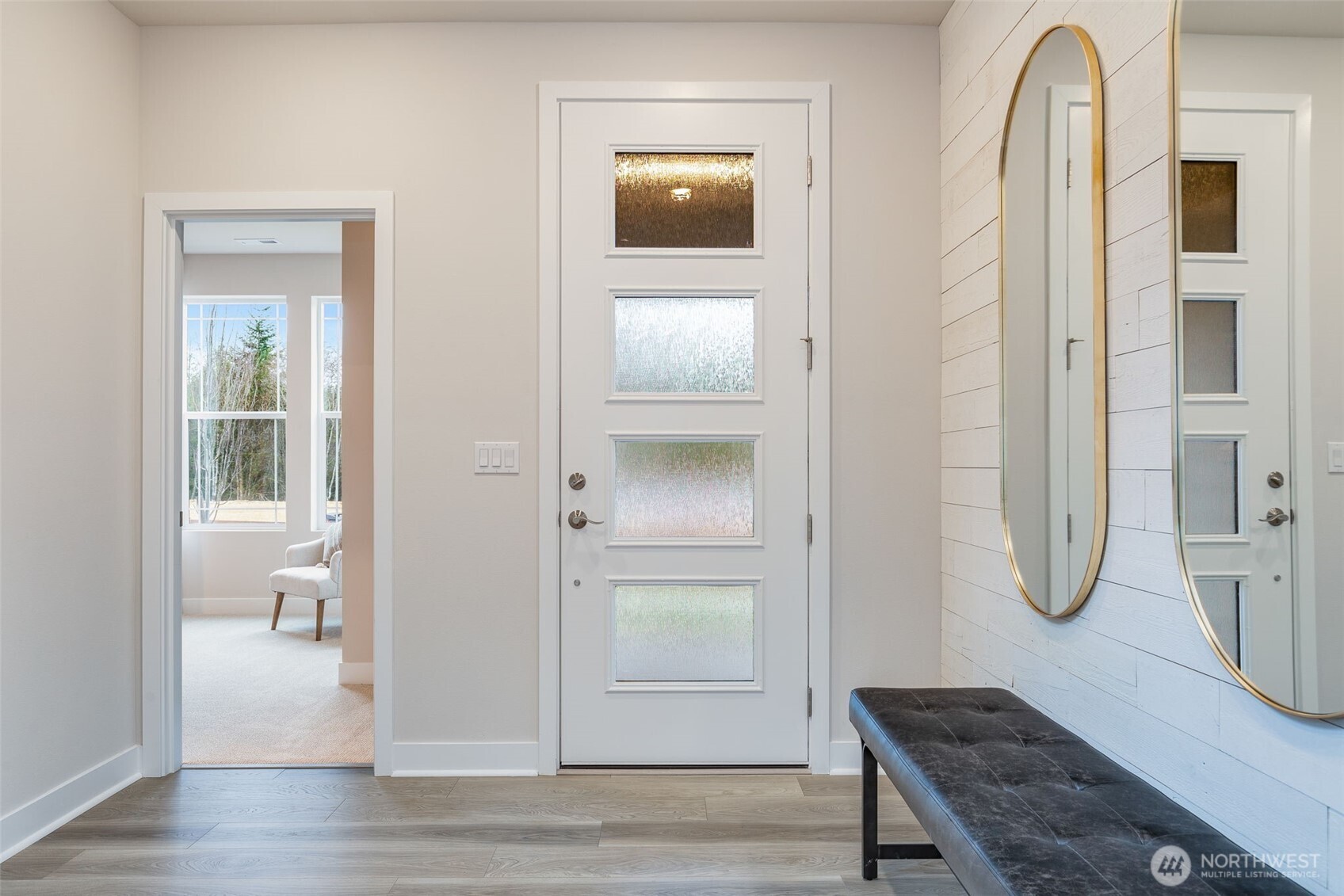 23338 Arbors Ter Road Northeast, Unit 201 Kingston, WA 98346 - Photo 3 of 17 a room with a door and wooden floor