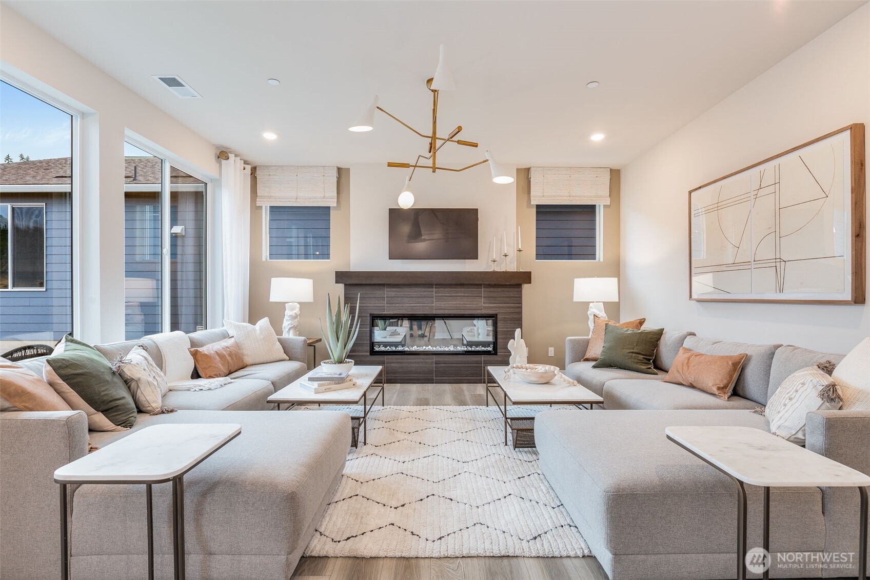 23338 Arbors Ter Road Northeast, Unit 201 Kingston, WA 98346 - Photo 5 of 17 a living room with furniture and a fireplace