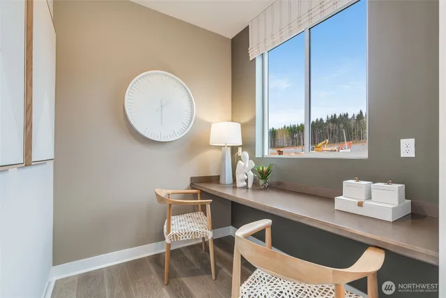 a dining room with a wooden table and chairs